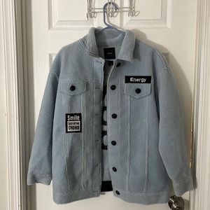 Light blue coat with patch details